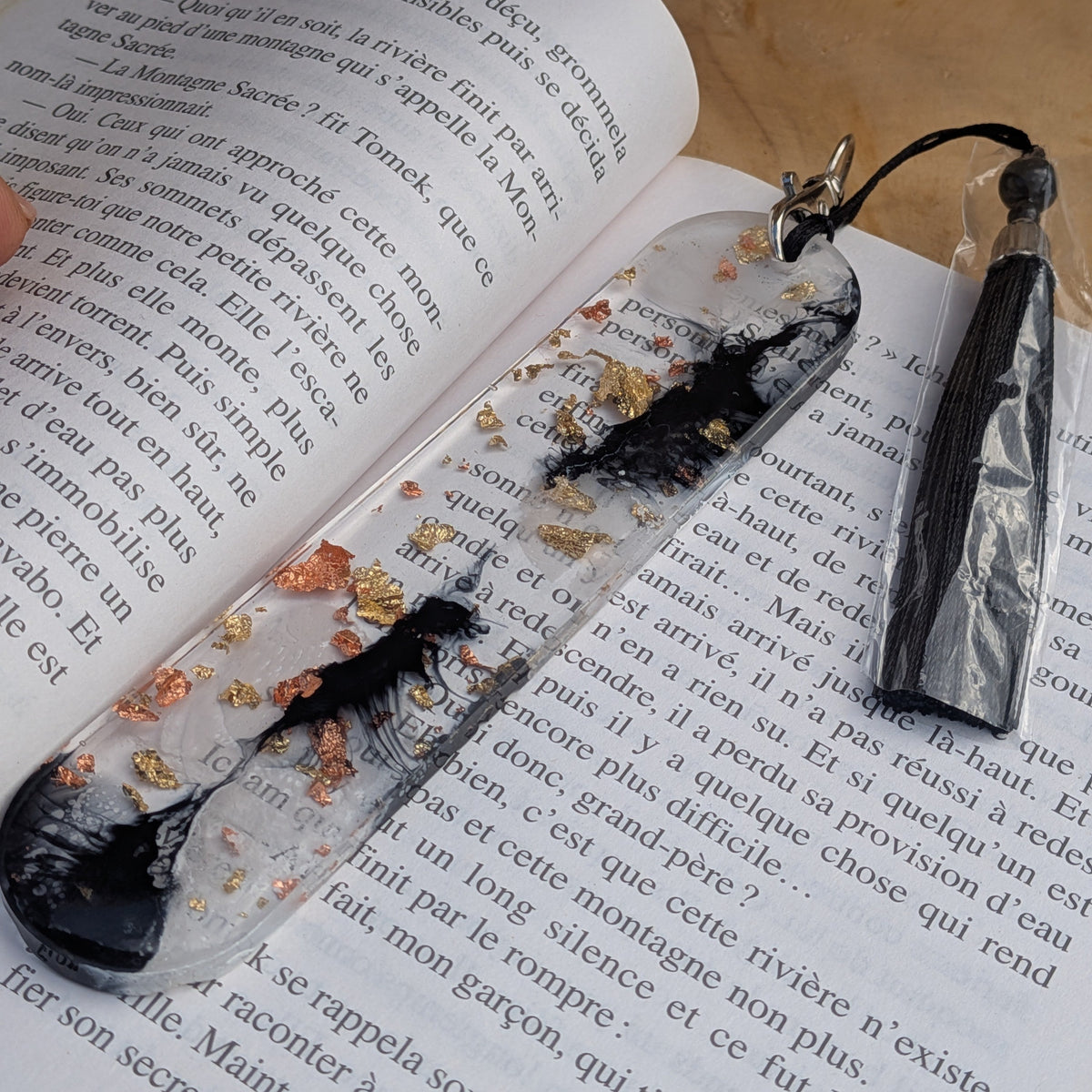 Clear resin bookmark with black ink storm and gold copper leaf on book pages – EL-Creations