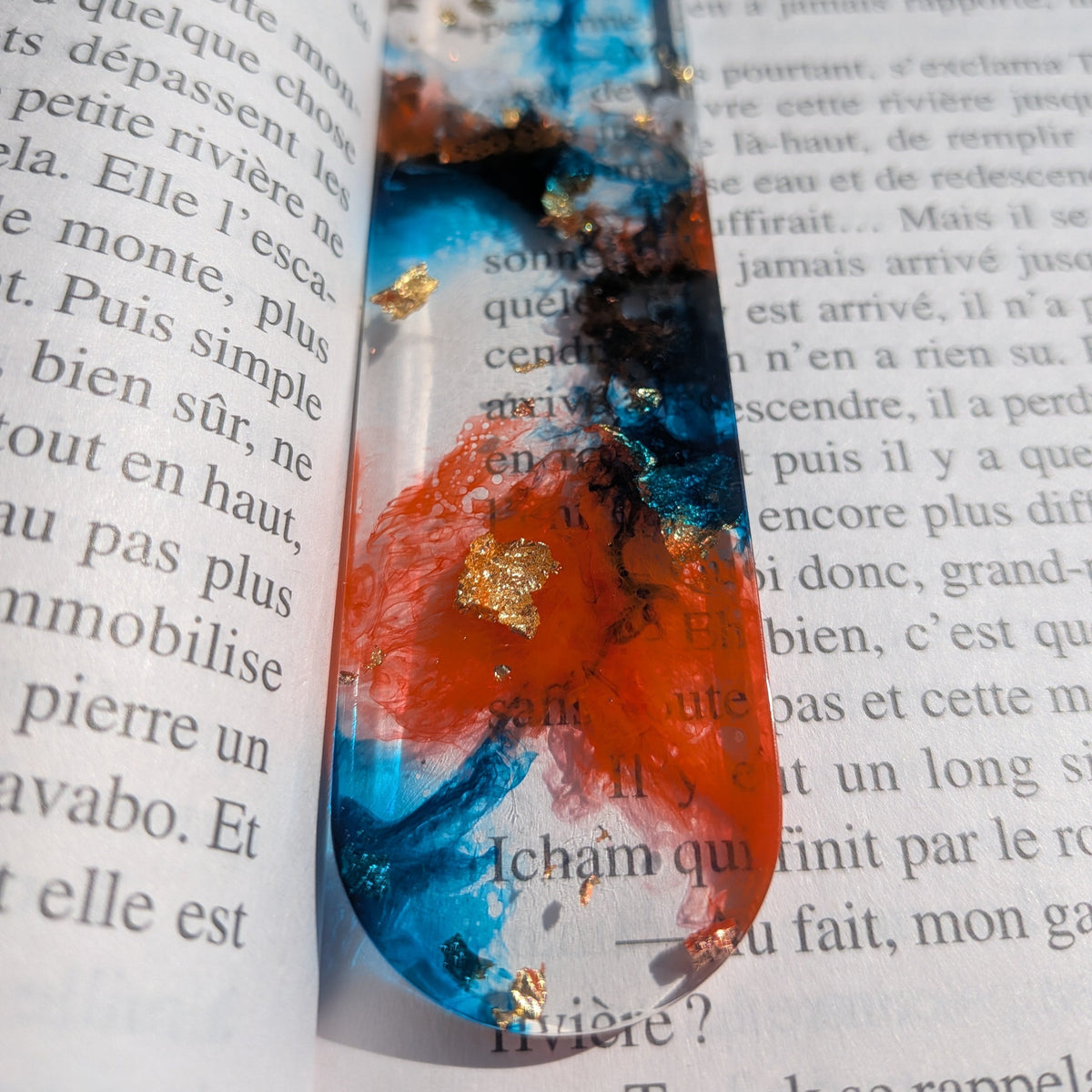 Macro close-up of orange and blue alcohol ink with gold copper leaf in resin bookmark – EL-Creations