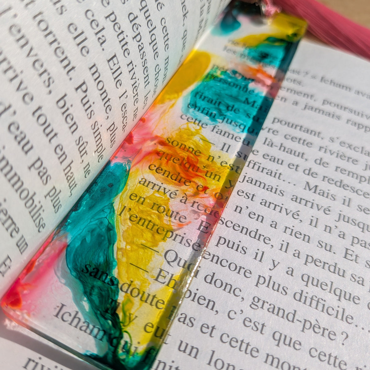 Macro close-up of orange and teal swirl in clear epoxy resin bookmark – EL-Creations