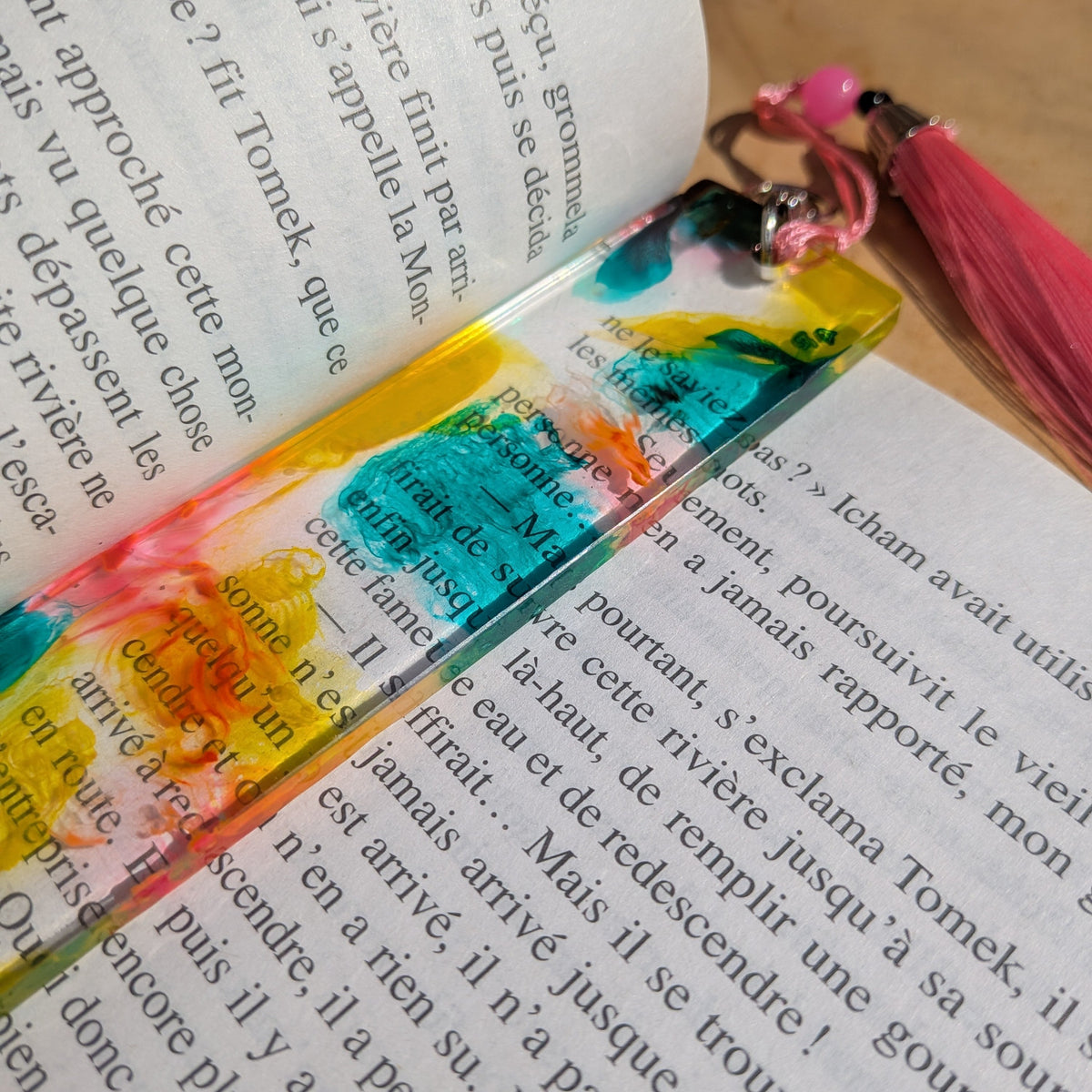 Full length view of colourful yellow teal pink resin bookmark on open book – EL-Creations