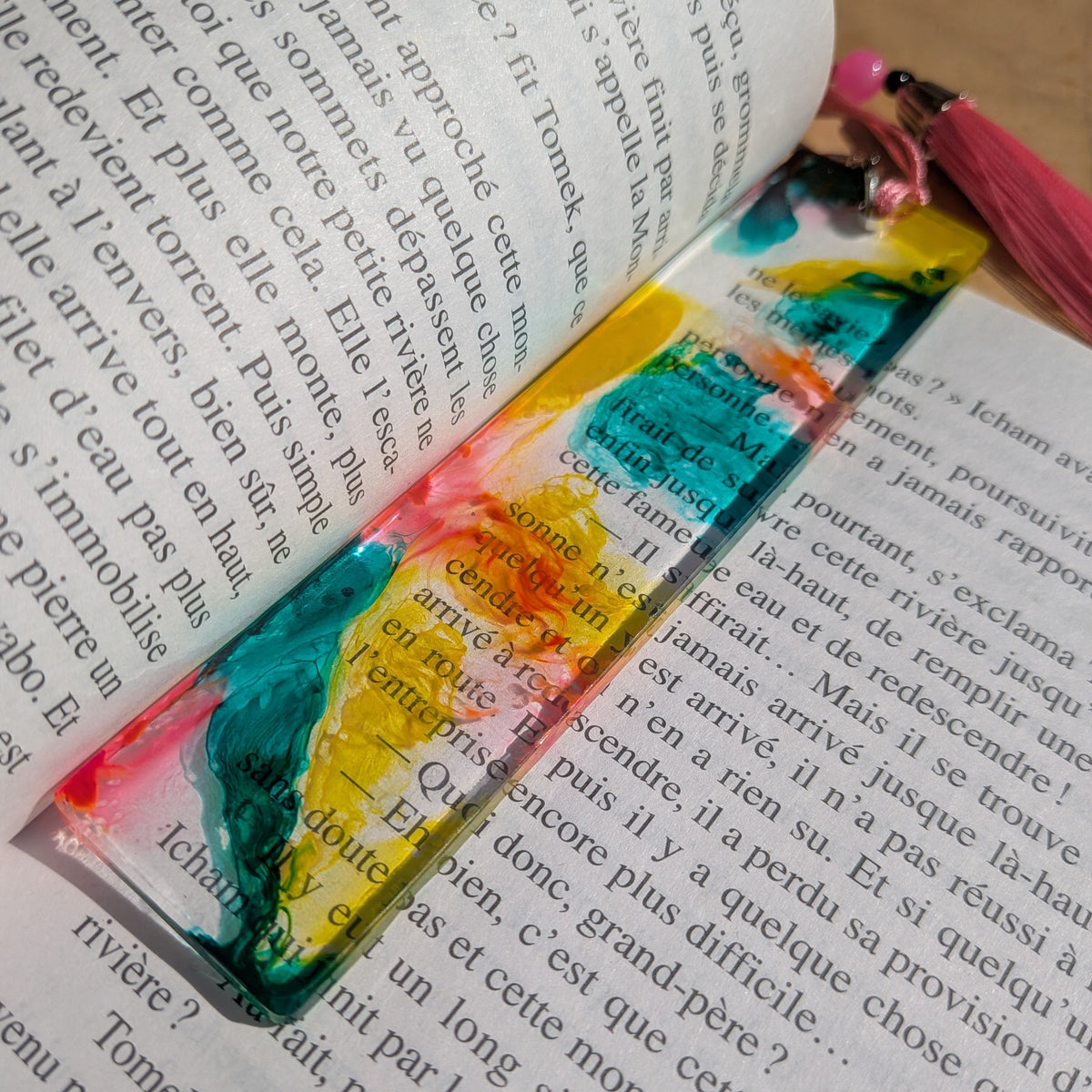 Top view of tropical resin bookmark with pink bead and tassel clasp on book – EL-Creations