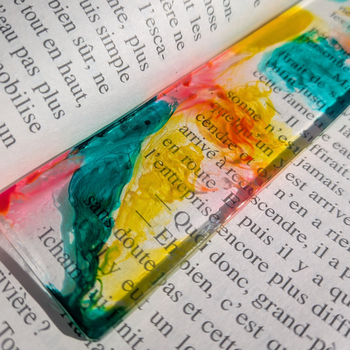 Macro detail of yellow and pink alcohol ink swirl in handmade resin bookmark – EL-Creations