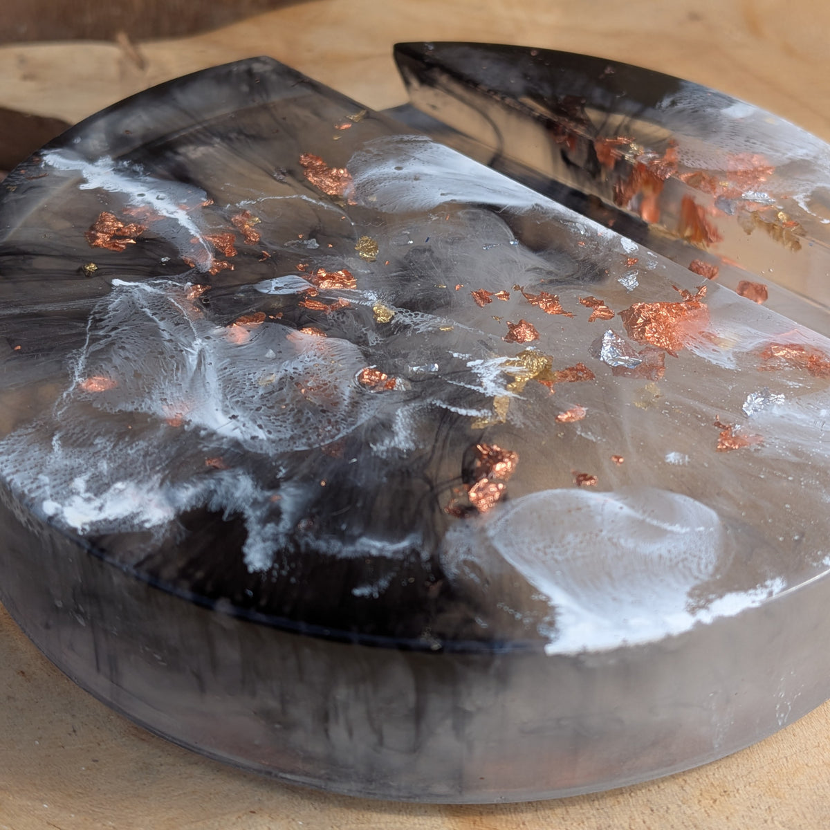 Close-up of black and white resin swirls with copper metallic flakes - EL-Creations