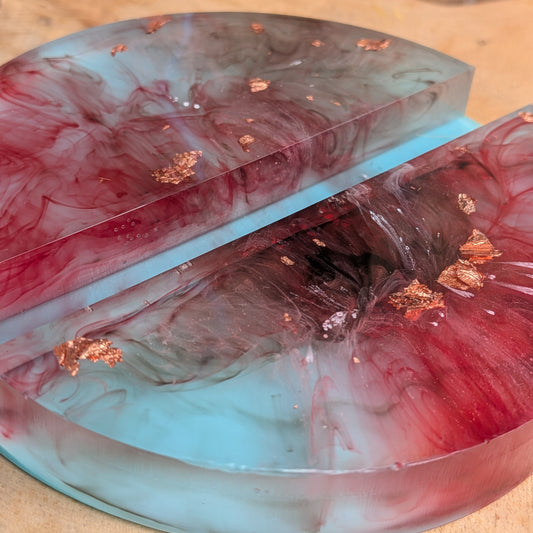 Turquoise and burgundy resin phone stand holding a smartphone - EL-Creations