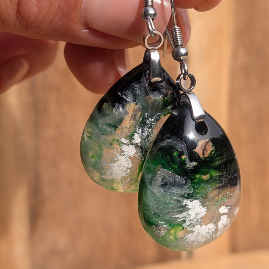 Handheld teardrop earrings showing emerald green swirls and translucent areas, EL-Creations
