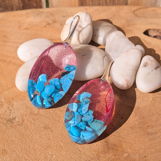 Side view of glossy resin earrings with red skeleton leaves and genuine turquoise chips, EL-Creations