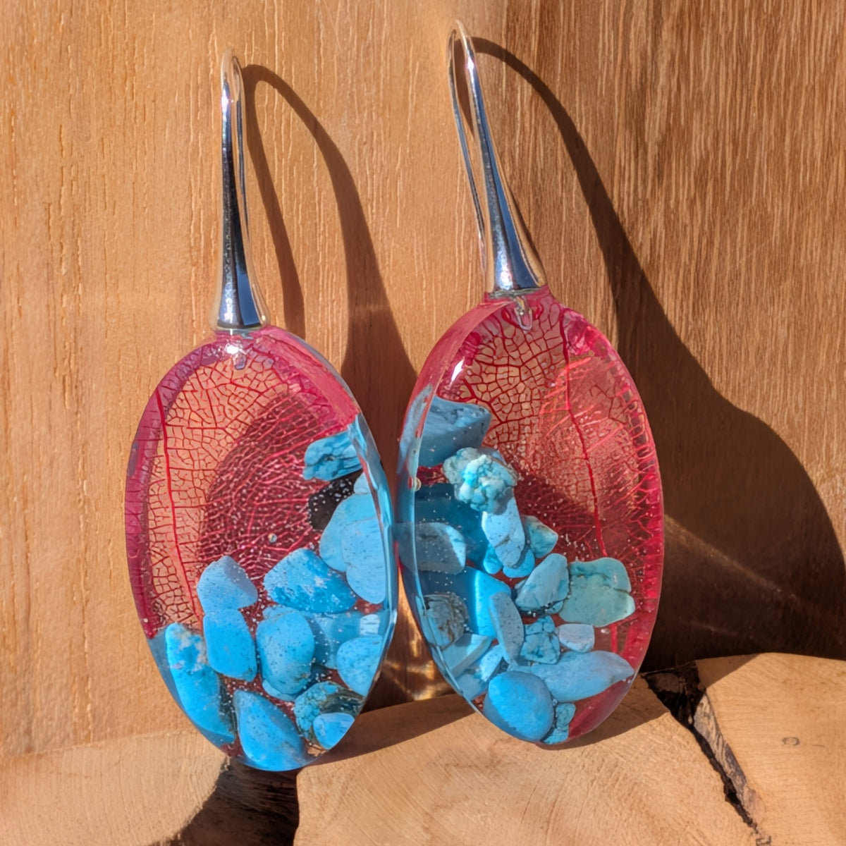 Pair of oval botanical resin earrings with red skeleton leaves, turquoise chips and silver-tone hooks, EL-Creations