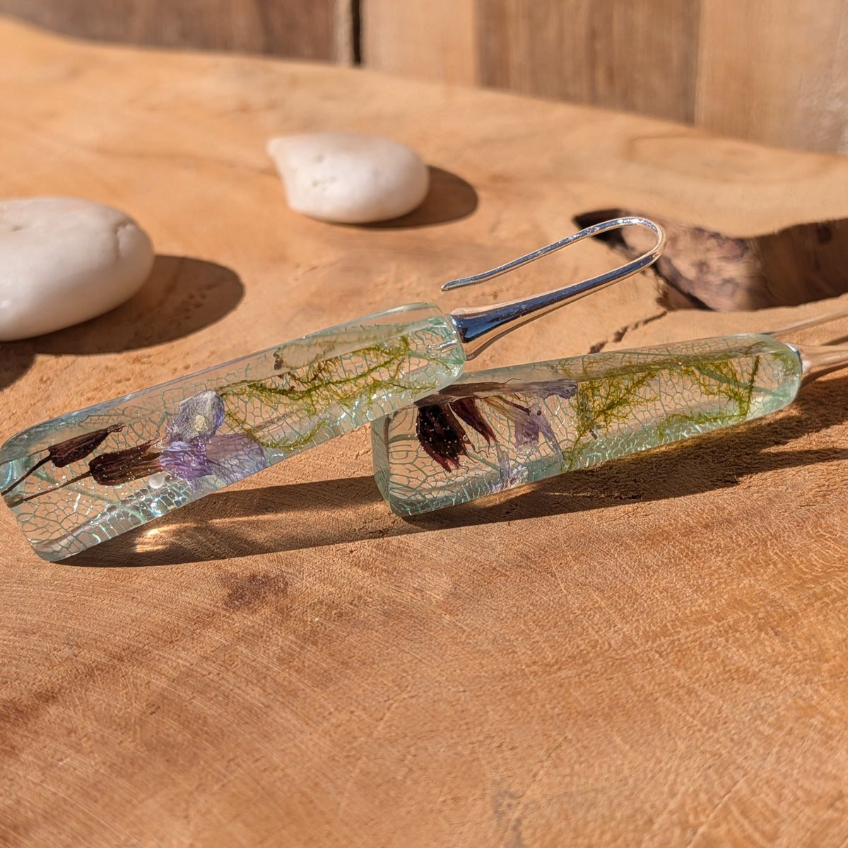 Side view of glossy botanical resin earrings showing moss and skeleton leaf details, EL-Creations
