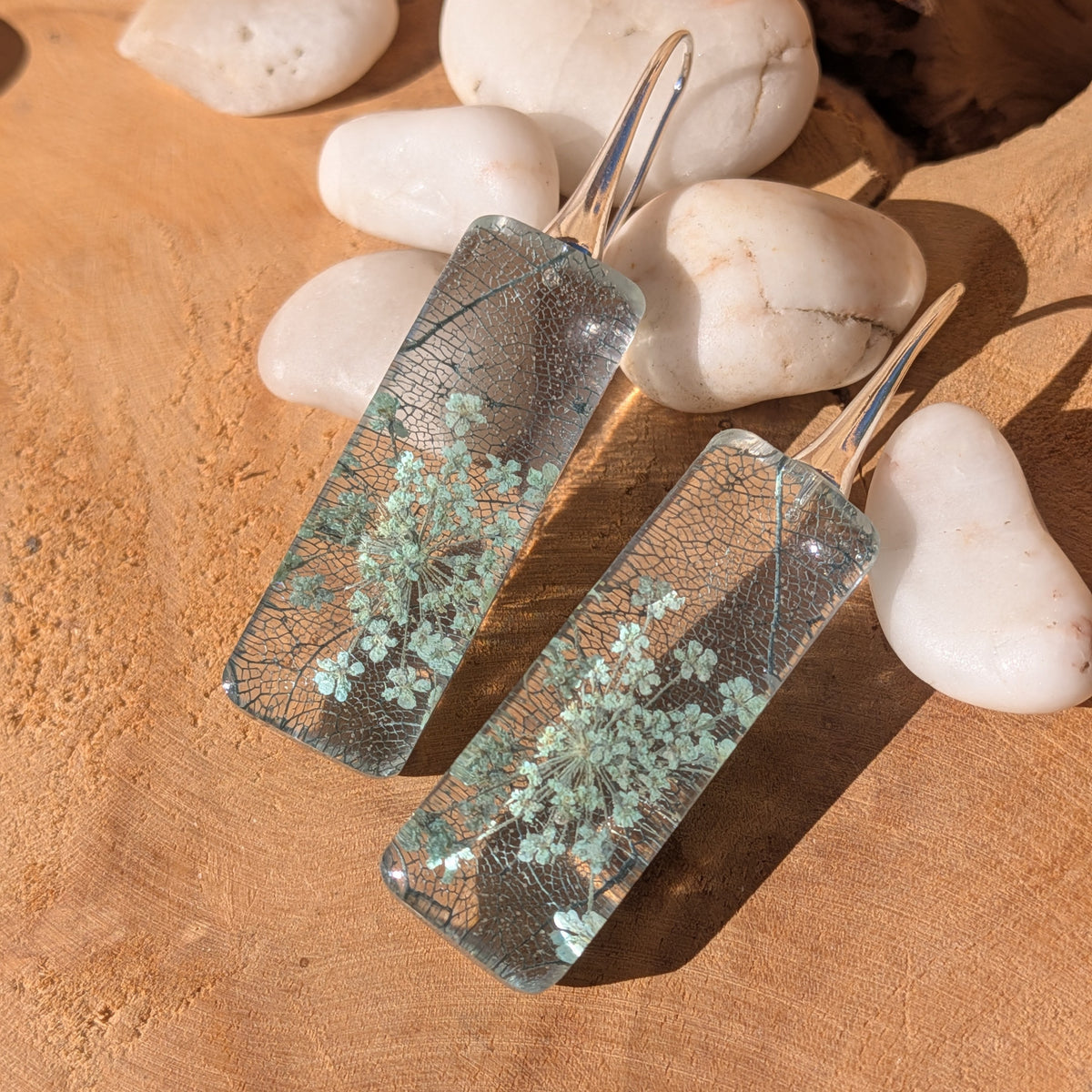 Side view of rectangular resin earrings showing preserved Queen Anne's lace and skeleton leaf, EL-Creations