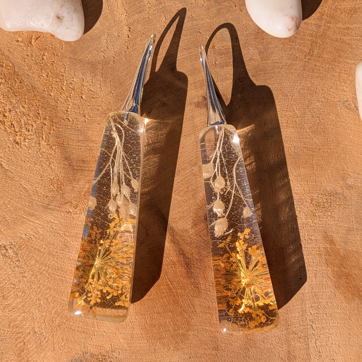Pair of autumn botanical resin earrings with silver-tone alloy hooks in sunlight, EL-Creations