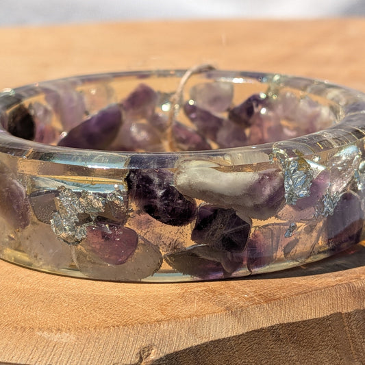 Close-up of real amethyst crystals and silver flakes inside clear resin bangle by EL-Creations
