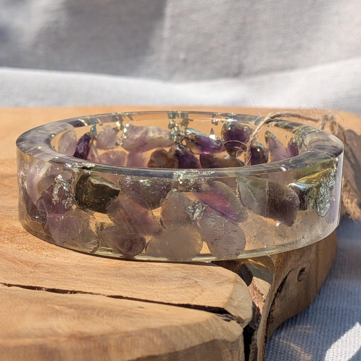 Clear resin bangle bracelet with real amethyst crystals and silver flakes in sunlight by EL-Creations