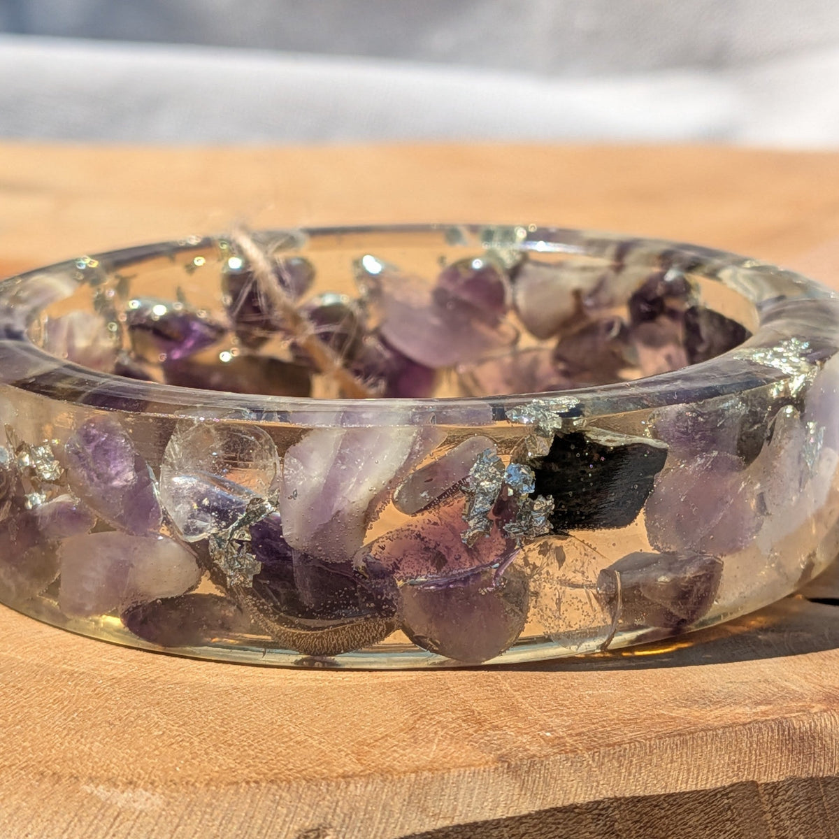 Side view of wide amethyst resin cuff bracelet in sunlight by EL-Creations