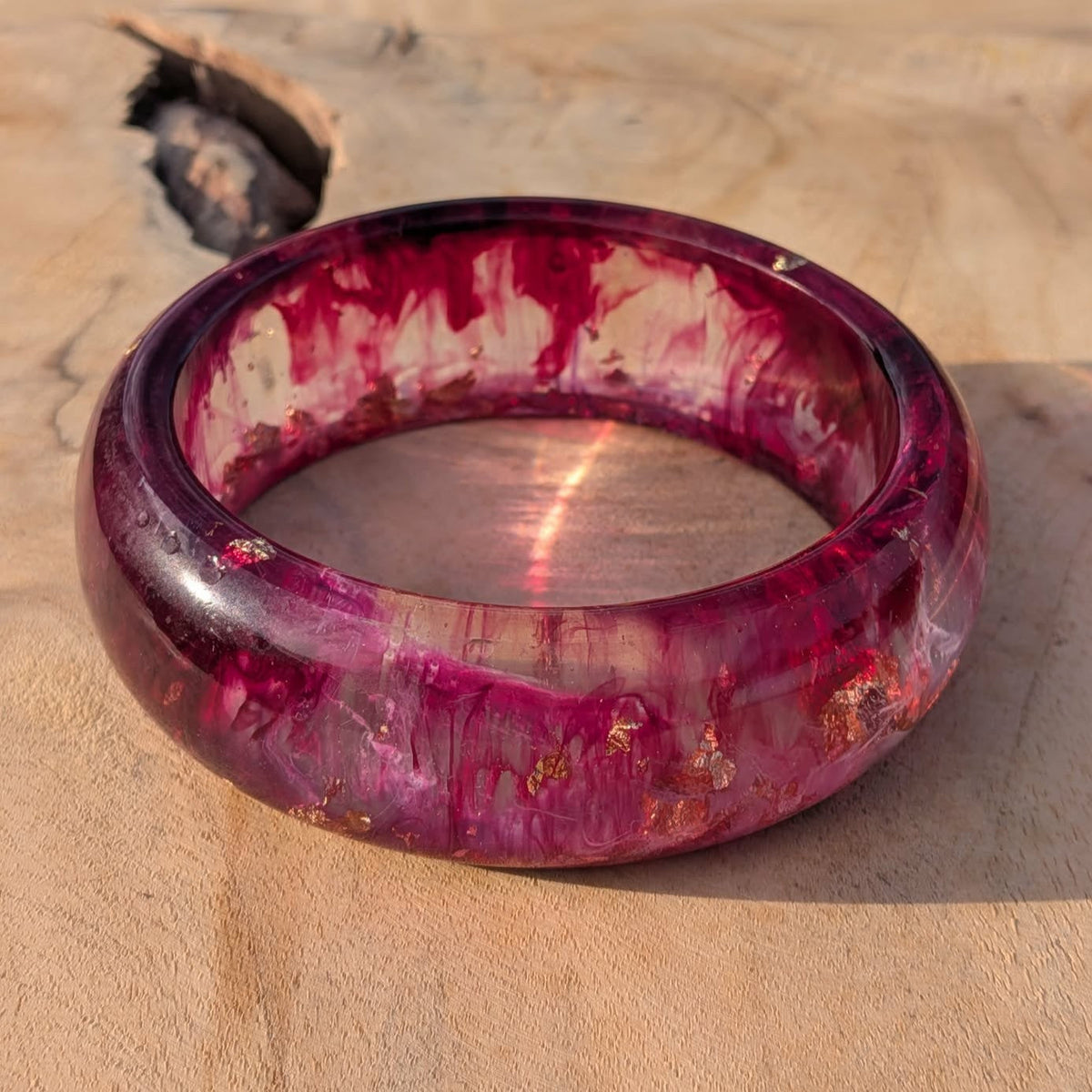 Three quarter view of wild berry resin bangle showing inner diameter and mirror polish – EL-Creations