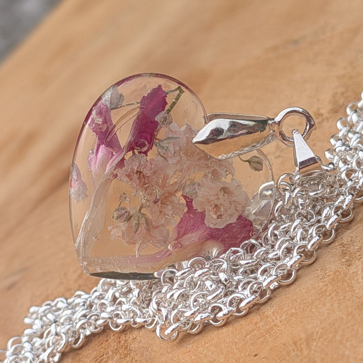Heart resin pendant with pink carnation and baby's breath flowers close-up by EL-Creations
