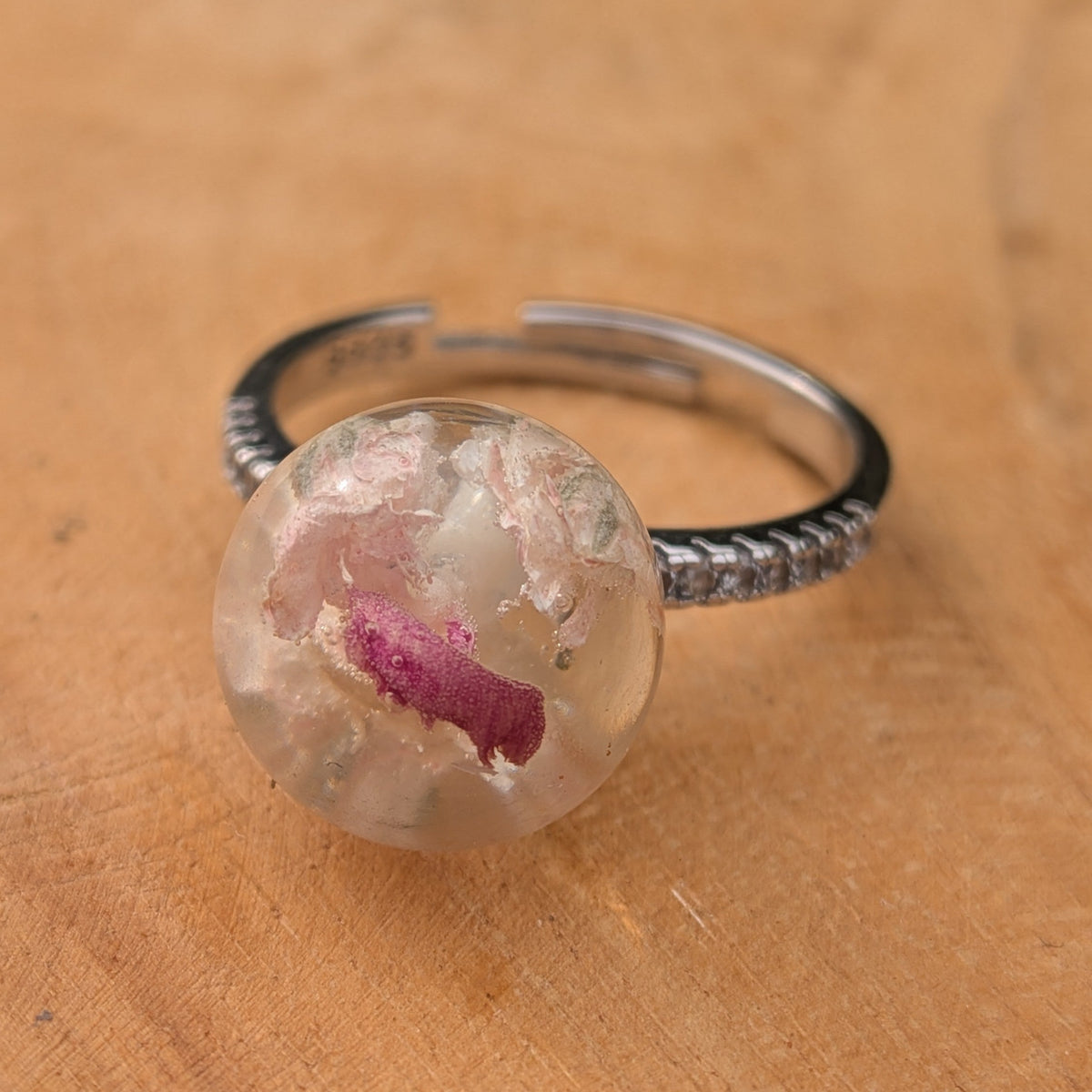 Front view of clear resin flower sphere ring with cubic zirconia band by EL-Creations