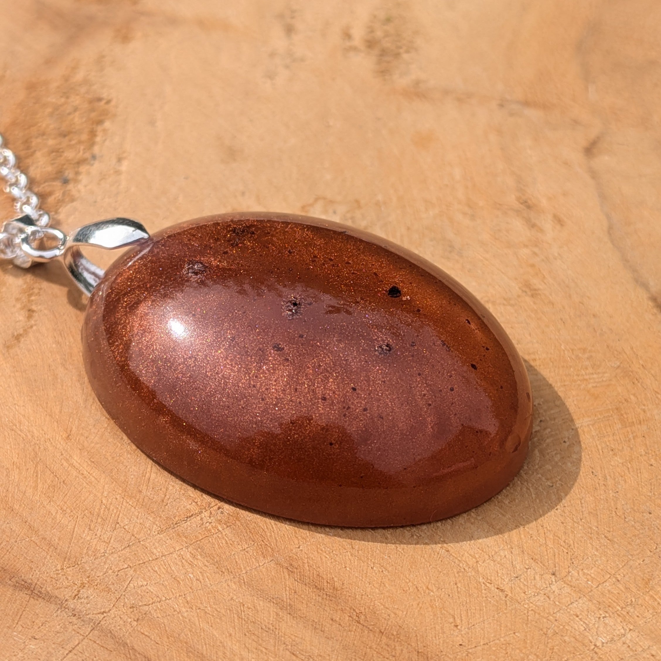 Side view of domed copper shimmer resin pendant on silver chain by EL-Creations