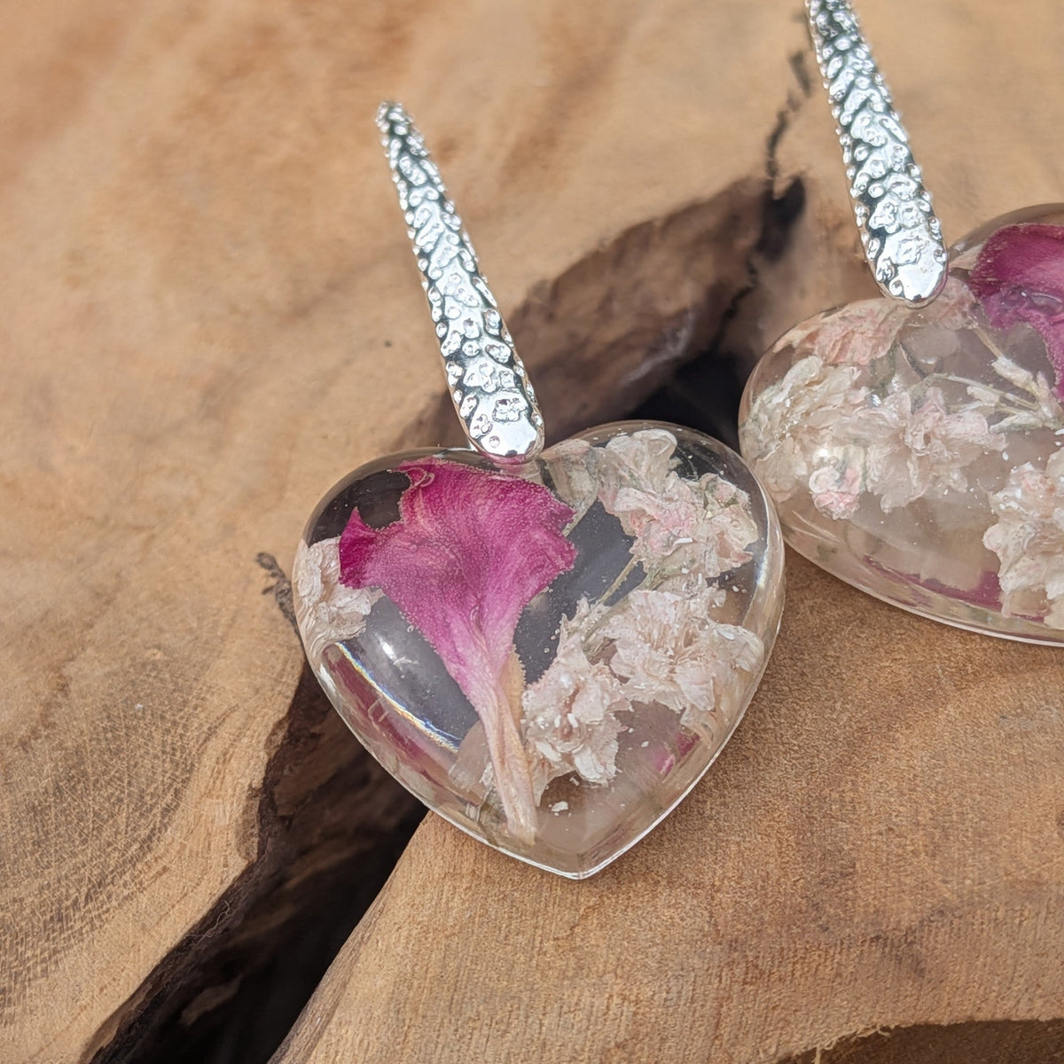 Pair of baby's breath carnation heart resin earrings on natural wood by EL-Creations