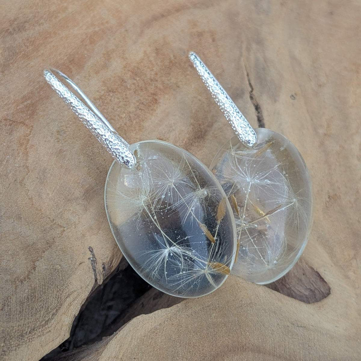 Dandelion make a wish resin earrings backlit against blue sky by EL-Creations