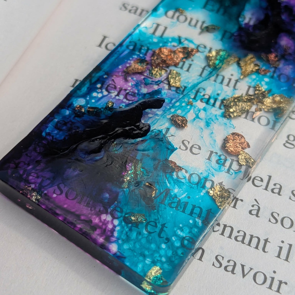 Side angle of teal and purple resin bookmark showing mirror polish and gold leaf detail – EL-Creations
