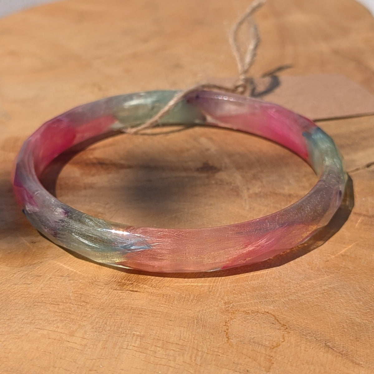Top view of pastel feather resin bangle on wooden surface by EL-Creations