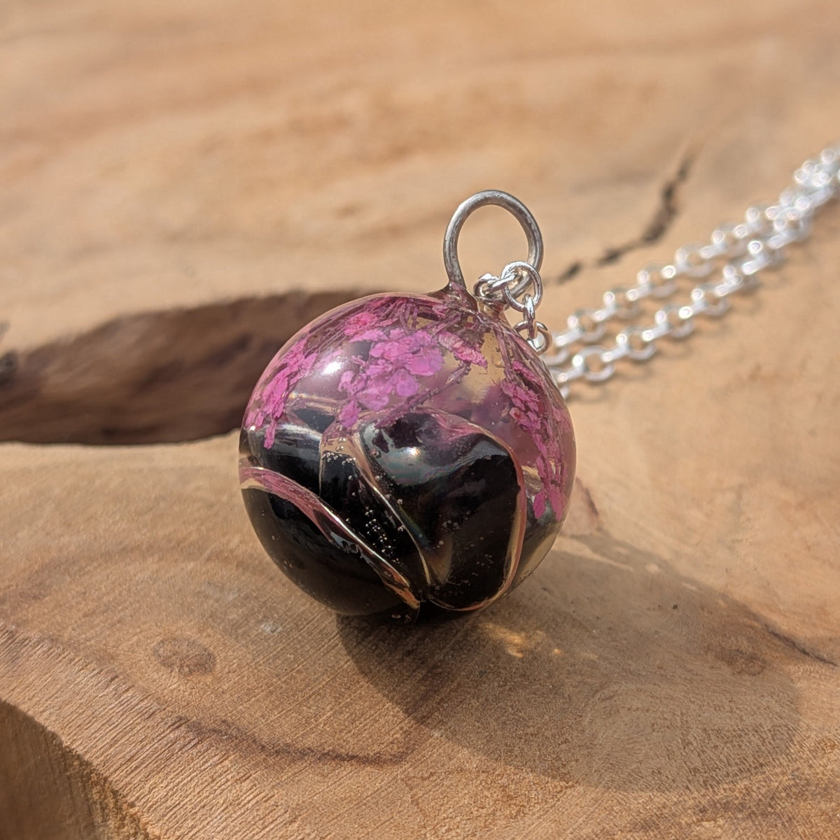 Two tone black and clear resin orb pendant with pink blossoms by EL-Creations