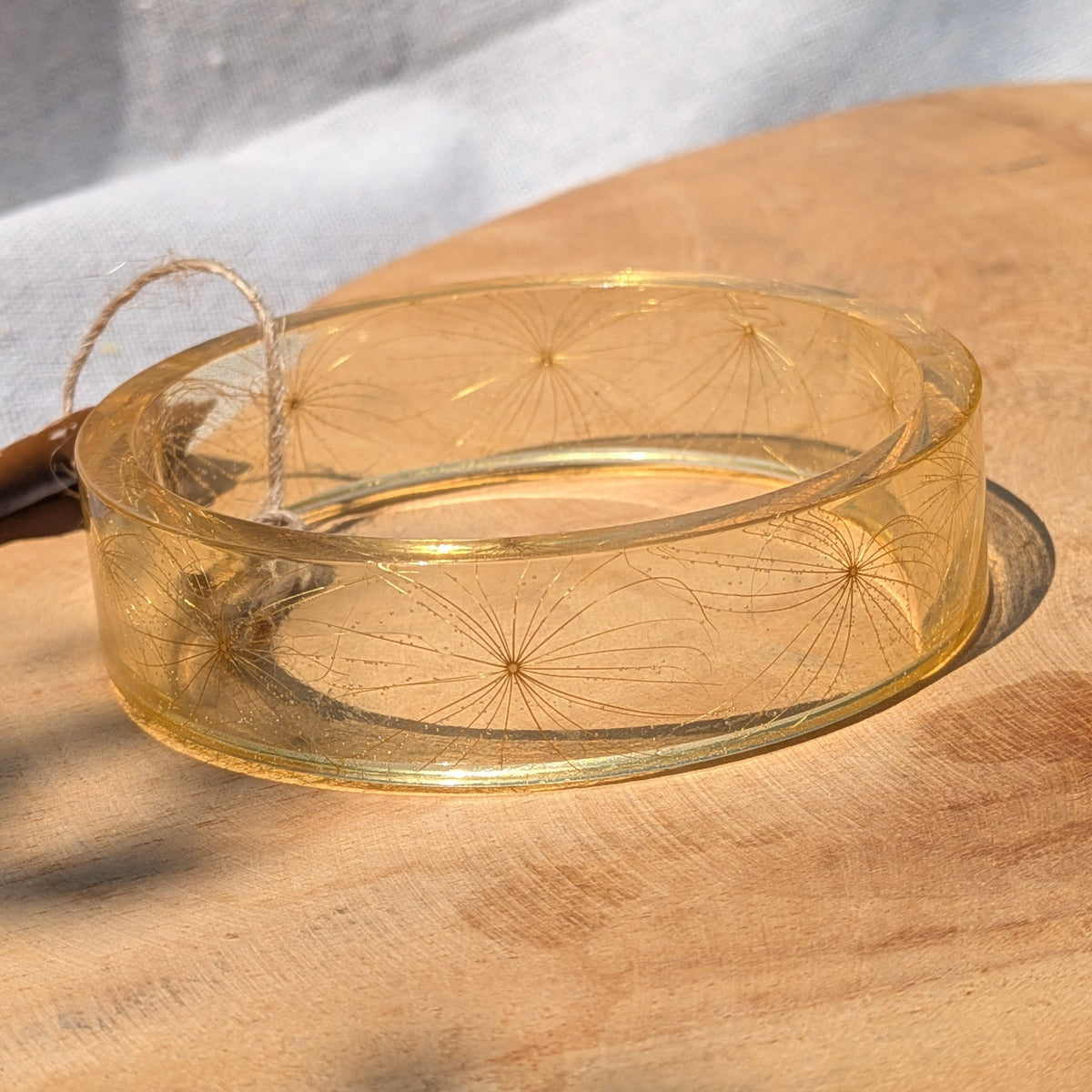 Resin cuff bracelet with delicate dandelion-like wish seeds on natural wood by EL-Creations