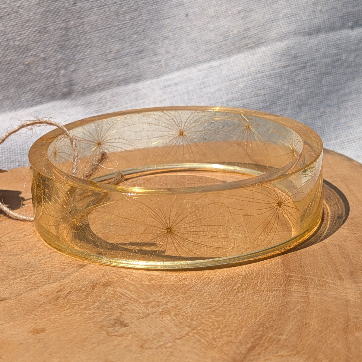Close-up of fine wild seeds inside clear golden resin bangle by EL-Creations